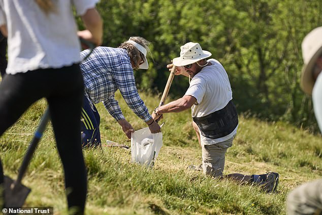 National Trust volunteers restore 180-foot Cerne Abbas Giant with fresh chalk.